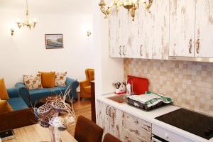 a kitchen with a counter and a living room at Deluxe Apartment Erdi in Ulcinj