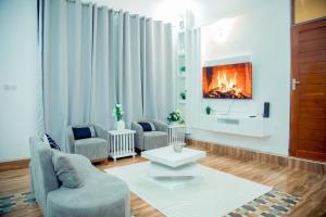 a living room with two chairs and a fireplace at Stand-alone- 2BR house in Dodoma in Dodoma