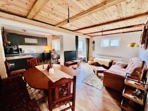 a living room with a couch and a table at Ciumarna Holiday House in Vatra Moldoviţei