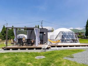 a house with a glass dome and a table and chairs at Kosugi Resort in Aso
