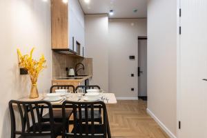 a dining room with a table and chairs at Светлая квартира-студия в 5-минутах от Мега Парк in Almaty +19 photos