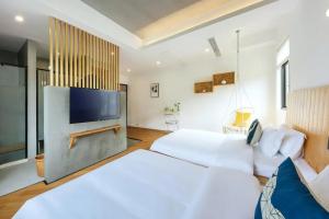 a bedroom with a large bed and a flat screen tv at Moganshan Moshe Yujia River Tracing Family Pool Bed and Breakfast 