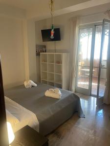 a bedroom with two beds with towels on them at M&J house in Reggio Calabria