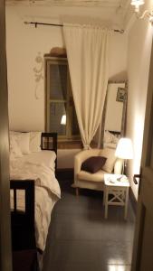 a bedroom with two beds and a mirror and a couch at Apartment Carmela in Rovinj