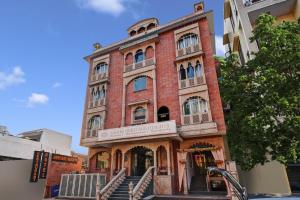 a red brick building with stairs in front of it at Super Townhouse OAK HOTEL Heritage Heights in Jaipur