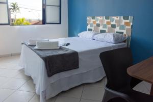 a bedroom with a large bed with two pillows on it at Hotel do Baú in Santa Rosa de Viterbo +53 photos