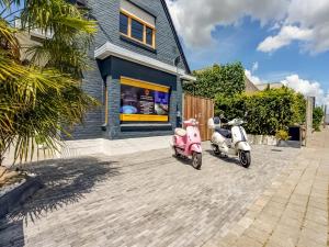 two scooters parked in front of a building at Peaceful Getaway with Spa in Avelgem