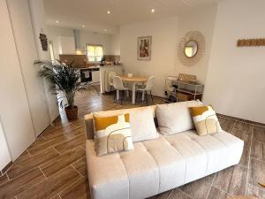 a living room with a couch and a table at charmante maison in Les Herbiers