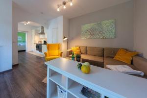 a living room with a couch and a table at Ferienwohnungen Wildblume in Winsen Aller