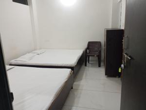 Postel nebo postele na pokoji v ubytování New Kashi balanand ashram + 6 fotografií