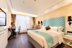 Postel nebo postele na pokoji v ubytování Xana Hotelle· Dalian Software Park University of Technology