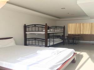 a bedroom with two bunk beds and a table at OYO 921 Sorrento Hotel And Resort in Vigan