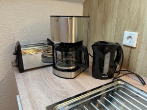 a coffee maker sitting on a counter next to a toaster at Ferienwohnung Goder 95168 in Rhauderfehn