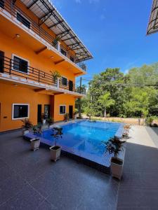 a swimming pool in front of a building at Papaya Guesthouse 
