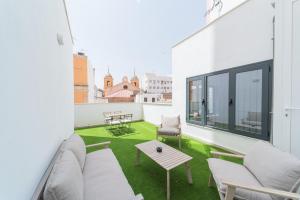 a living room with a couch and a table at Apartamentos San Francisco con Terraza privada by Expoholidays in Almería