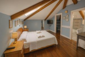 a bedroom with a bed with two towels on it at The Secret Garden Relais in Piano di Sorrento