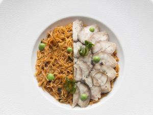 a white plate of food with chicken and noodles at The Cookbook Gastro Boutique Hotel & SPA in Calpe