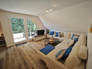 a large living room with a couch and a tv at Ferienwohnung Goder 95168 in Rhauderfehn