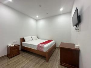 a small bedroom with a bed and a tv at Motel Phuong Linh in Da Nang +46 photos