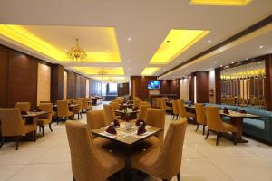 a dining room with tables and chairs at Hotel Kohinoor Palace, Ludhiana in Ludhiana