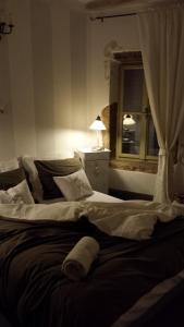 a large bed in a bedroom with a window at Apartment Carmela in Rovinj