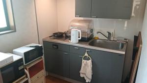 a kitchen with a sink and a counter top at 坂本邸 in Maniwa