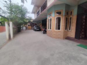 a building with a car parked outside of it at Kaziranga Homestay in Guwahati +4 photos