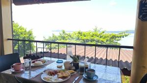a table with two plates of food on a balcony at Eagles Nest Beach Resort Room 6 in Samal
