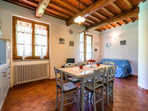 a kitchen and dining room with a table and chairs at Farmhouse in Tuscany with Panoramic Pool in Castiglion Fiorentino