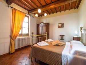 a bedroom with a bed and a large window at Farmhouse in Tuscany with Panoramic Pool in Castiglion Fiorentino +32 photos
