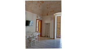 a living room with a table and a television at Masi suite in Monopoli +7 photos