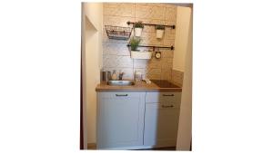 a small kitchen with a sink and a counter at Masi suite in Monopoli