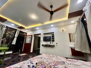 a bedroom with a ceiling fan and a bed at Monsoon magic Home stay in Kuttālam +5 photos