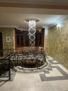 a dining room with a chandelier in a building at Kajaznuni hotel-hostel in Yerevan