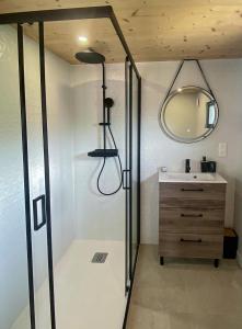 a bathroom with a sink and a mirror at Chalet Cosy neuf sur terrain privé clôturé 600m2 in Faverges +1 photo