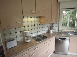 a kitchen with a sink and a stove top oven at West Flanders Vacation Home in Le Bizet +12 photos