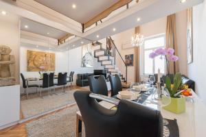 a dining room and living room with a table and chairs at Bridge & Castle Art Apartman in Budapest