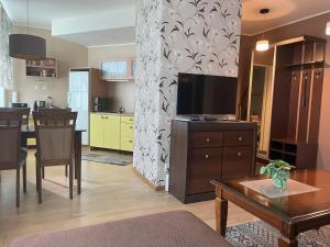 a living room with a television and a dining room at Akord Apartments with FREE PARKING in Pärnu