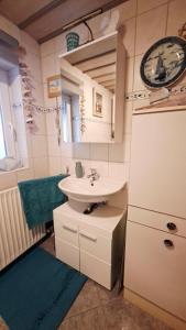 a bathroom with a sink and a mirror at Hengeler's hof in Altusried +105 photos