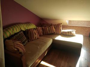 a couch in the corner of a room at Les amandiers in Gigors