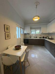 a kitchen with a table and chairs in a room at Olivia 42 in Nafpaktos