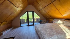 a bedroom with a large bed in a attic at Start Rest House in Hrazdan +15 photos