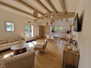a living room with a couch and a table at Maison familiale à Barbâtre face à la dune, 3 chb, 2 SDB, 8 personnes in Barbâtre