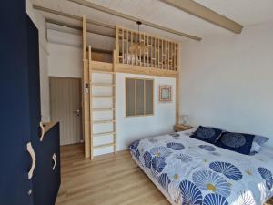 a bedroom with a bed and a loft bed at Maison familiale à Barbâtre face à la dune, 3 chb, 2 SDB, 8 personnes in Barbâtre