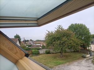 a view of a yard from a window of a house at Chez Lullu in Saint-Quentin-Lamotte-Croix-au-Bailly