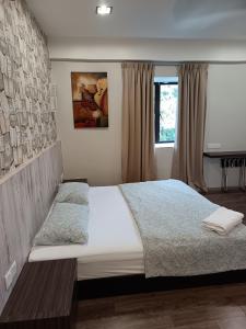 a bedroom with a large bed and a window at Lumut Valley in Lumut +27 photos