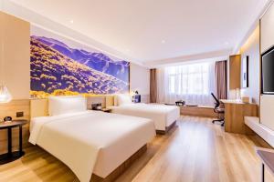 Postel nebo postele na pokoji v ubytování Atour Hotel Hohhot Yinhé South Street