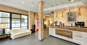 a lobby of a hospital with a couch and a counter at Hotel Sercotel Alfonso VI in Toledo