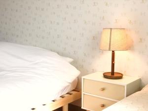 a bedroom with a bed and a lamp on a night stand at Chiba - House - Vacation STAY 41221v in Chiba +15 photos