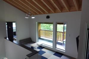 a living room with a staircase and a balcony at CLOUD9 - Vacation STAY 46105v in Rusutsu +1 photo